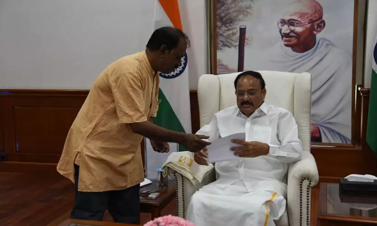 BJP senior leader Karuturi Srinivasa Rao submitting a petition for taking up repairs to approach road to Vice-President M Venkaiah Naidu in New Delhi on Wednesday