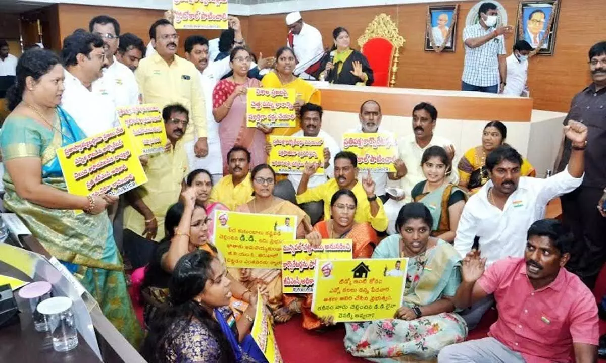 Opposition party corporators raising slogans against the ruling party in front of the Mayor’s podium at GVMC in Visakhapatnam on Wednesday