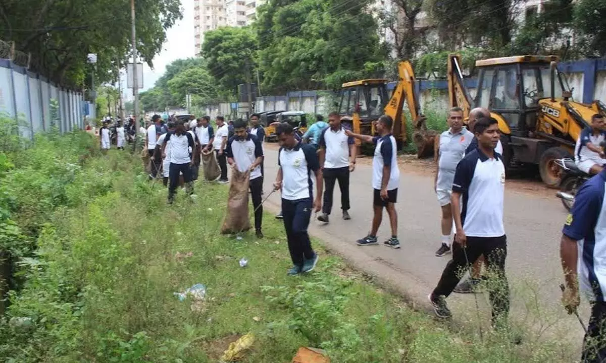 Personnel from various units of Indian Coast Guard District Headquarters-6 (AP) taking part in a cleanliness drive in Visakhapatnam on Wednesday