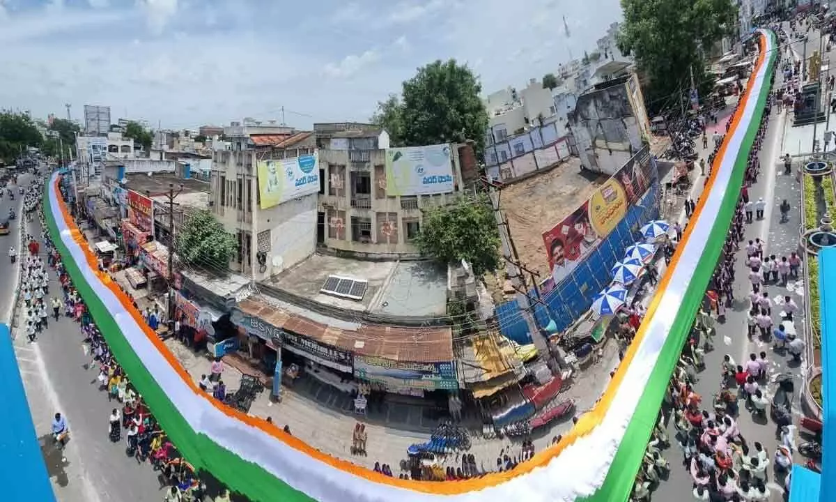 Students taking out a rally with 1,000 metres long national flag in Narasaraopet on Wednesday