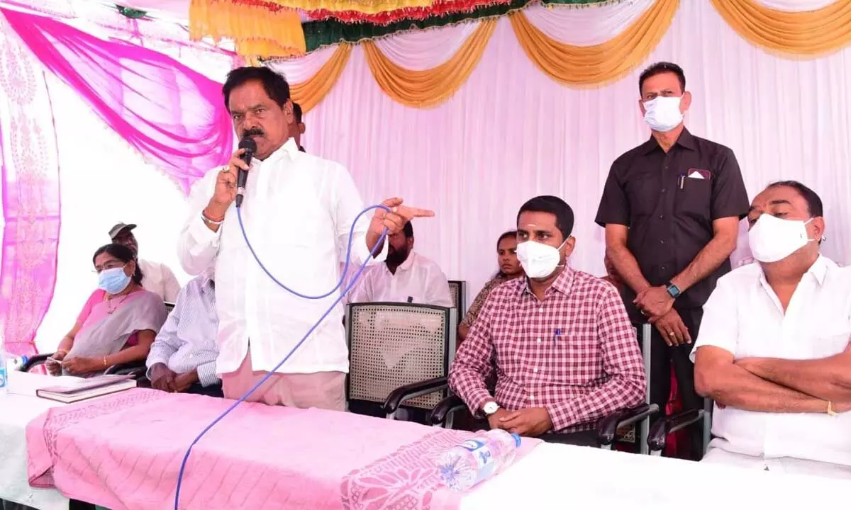 Deputy Chief Minister K Narayana Swamy addressing a meeting in Chittoor on Wednesday. District Collector M Hari Narayanan is also seen.