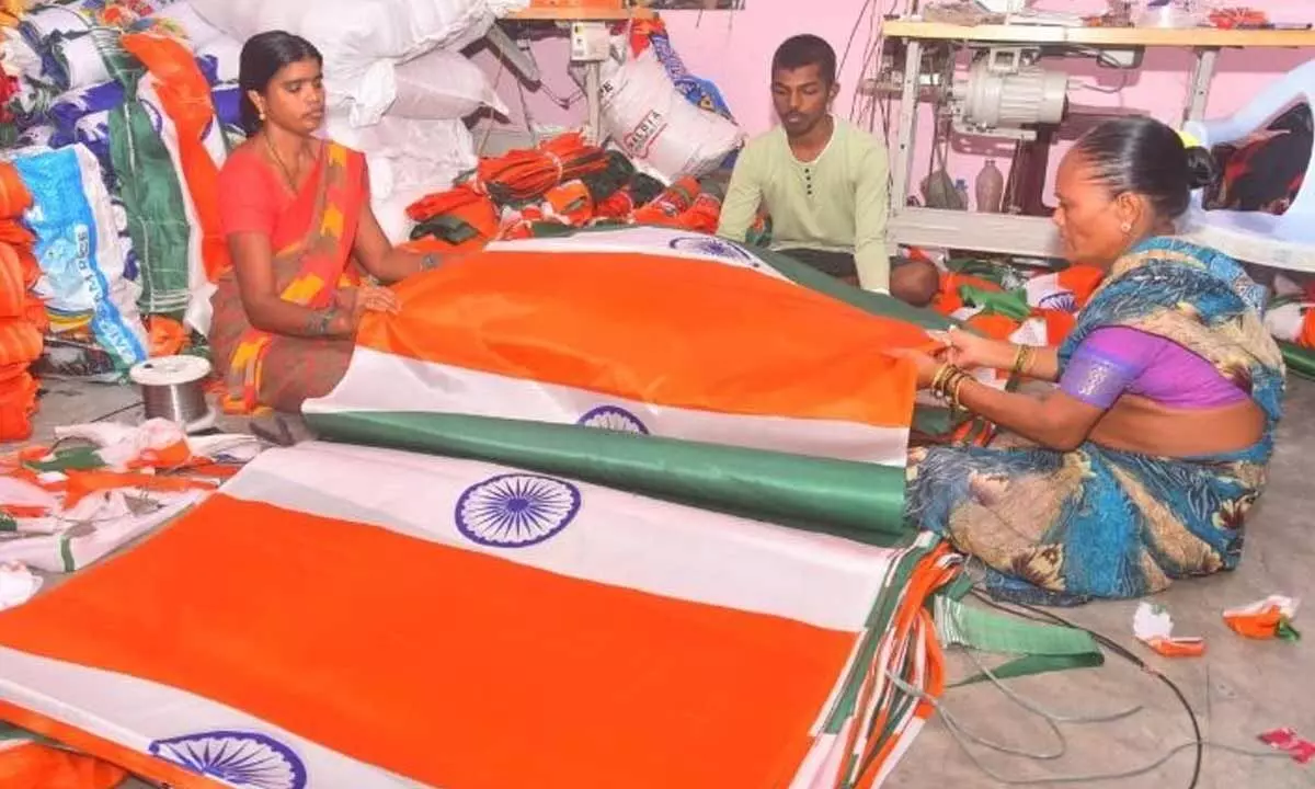 Weavers engaged in making national flags at Sircilla on Wednesday