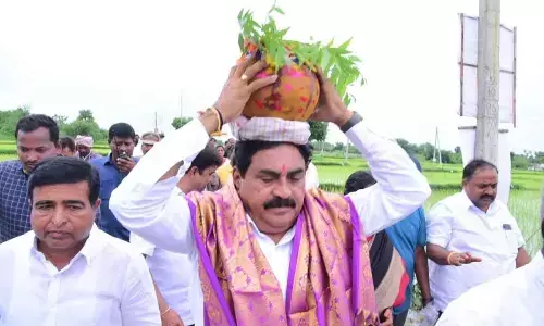 Minister for Panchayat Raj and Rural Development Errabelli Dayakar Rao carrying bonam at Kodakandla in Jangaon district on Tuesday
