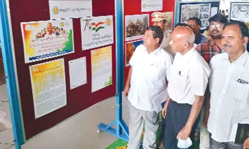 RTC Zone 4 Executive Director K Gopinath Reddy and DTPO T Chengal Reddy looking at the freedom fighters photos displayed at the photo exhibition at RTC bus stand in Tirupati on Thursday