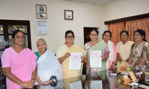 Maris Stella College Principal Dr Sr Jasintha Quadras and MAARPU Trust Director Ravuri Suez showing MoU at the college in Vijayawada on Friday. Freedom fighter and founder of MAARPU Trust Ravuri Manorama (second from left) is also seen.