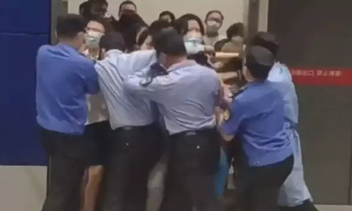 Guards at Ikea try to close the doors of the store in Shanghai