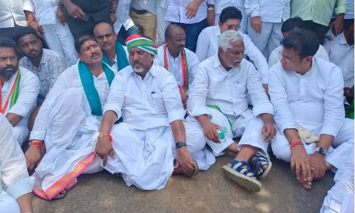 Congress MLAs staging a sit-in at Gurralabailu tribal hamlet in Dummagudem mandal in Kothagudem district on Tuesday