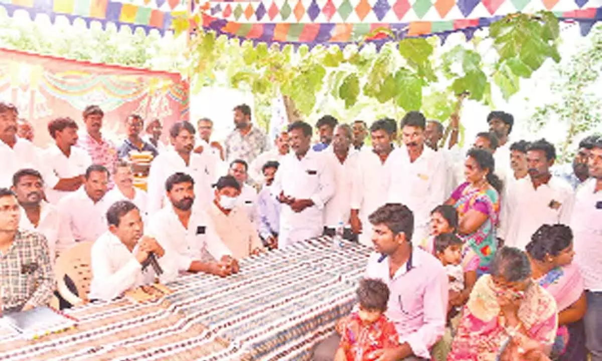 State SC Commission chairman Victor Prasad along with Dalit leaders and police officials speaking to the family of Indrasenaiah at TR Kandriga SC Colony in Puttur mandal on Thursday