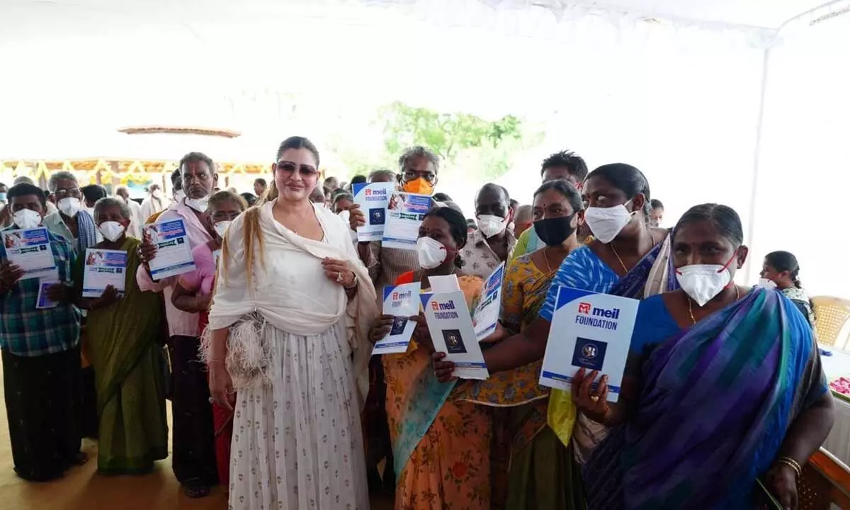 Sudha Reddy Foundation founder P Sudha Reddy posing with people, who attended free medical camp at Dokiparru on Friday