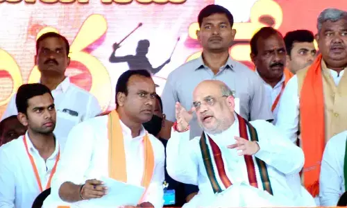Union Minister Amit Shah having a word with Komatireddy Rajagopal Reddy during BJP meeting in Munugodu on Sunday