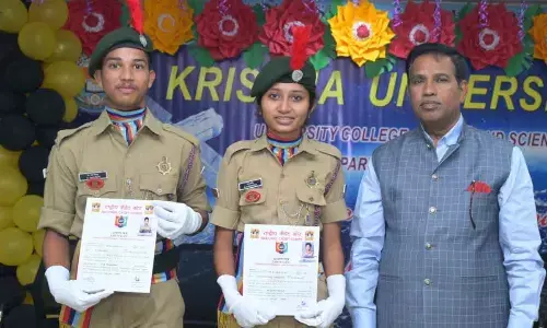 Vice-Chancellor Prof KB Chandrasekhar along with the two NCC students of Krishna University College of  Engineering and Technology