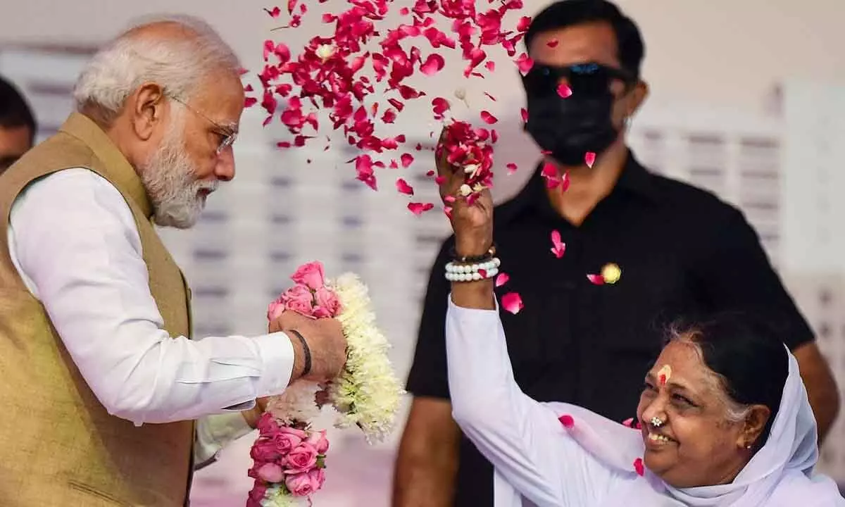 PM Modi being showered with flower petals by spiritual leader Mata Amritanandamayi during inauguration of state-of-the-art Amrita Hospital in Faridabad on Wednesday