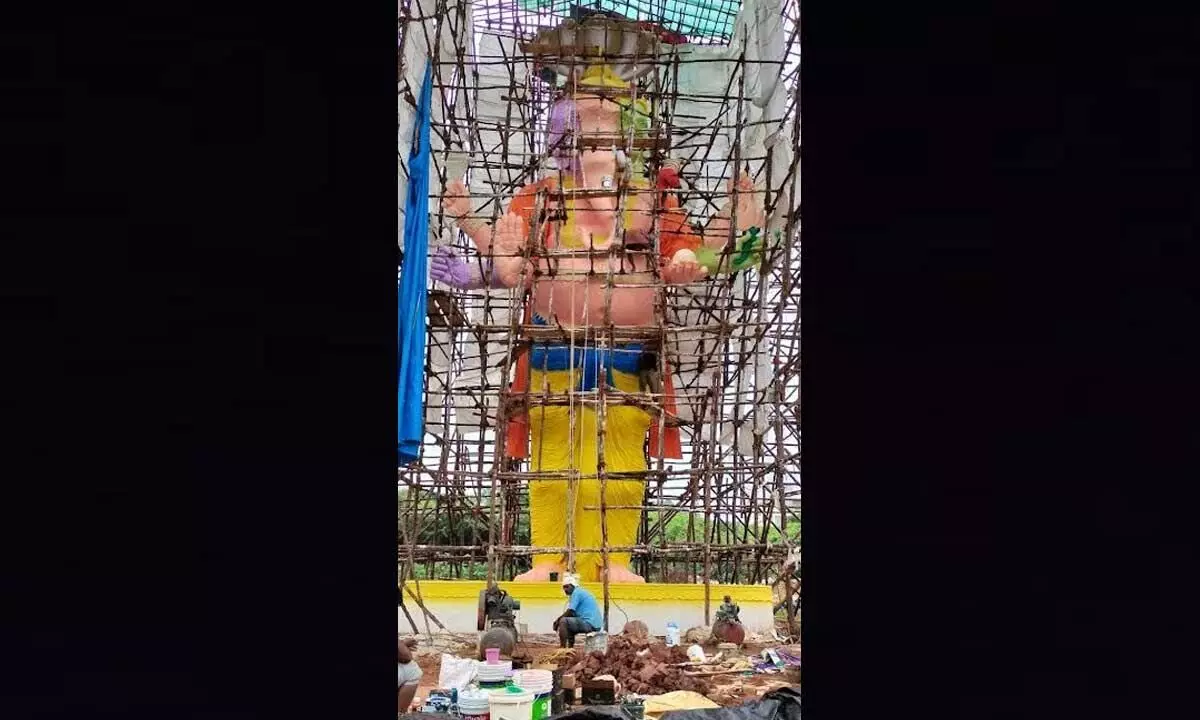 A team of workers led by Khairatabad-based sculptor Chinnaswamy Rajendran working on the tallest Ganesh idol at Lanka Grounds, Gajuwaka in Visakhapatnam