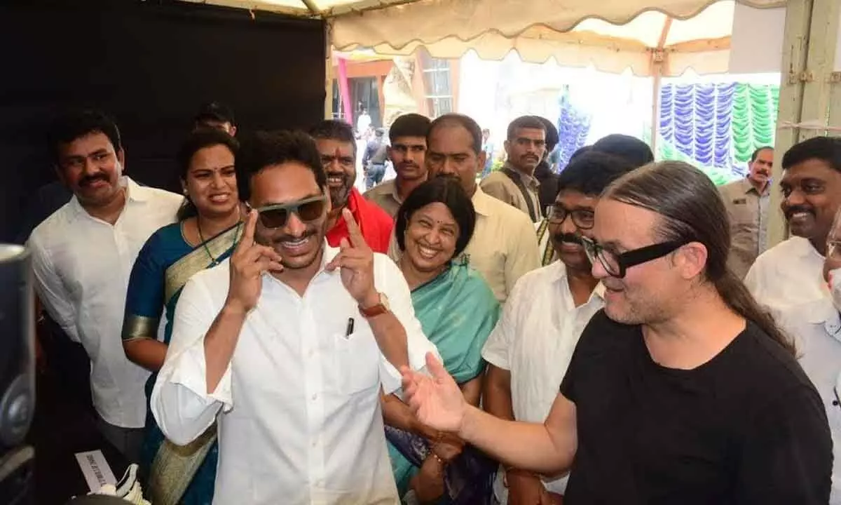 Chief Minister YS Jagan Mohan Reddy trying  sunglasses made from plastic waste at a stall exhibited by Parle in Visakhapatnam on Friday