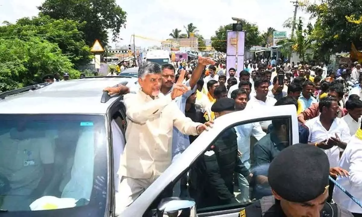 TDP chief N Chandrababu Naidu showing victory sign at a roadshow in Kuppam on Friday