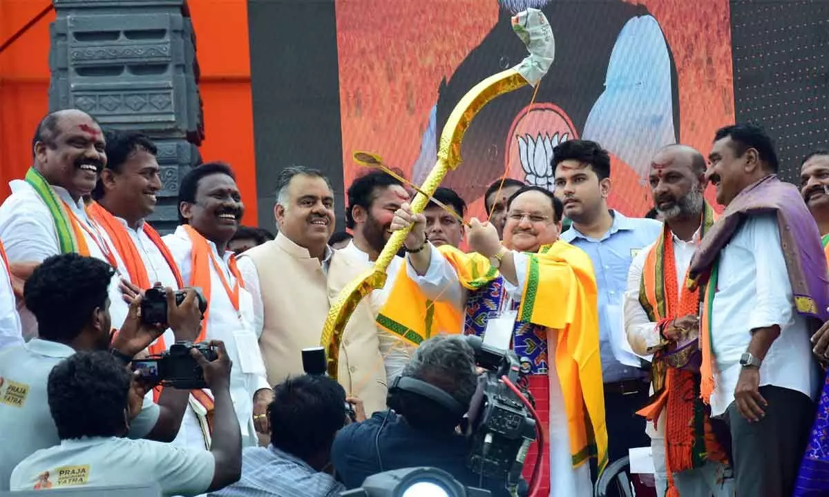 BJP national president J P Nadda wielding a bow at a public meeting in Hanumakonda on Saturday