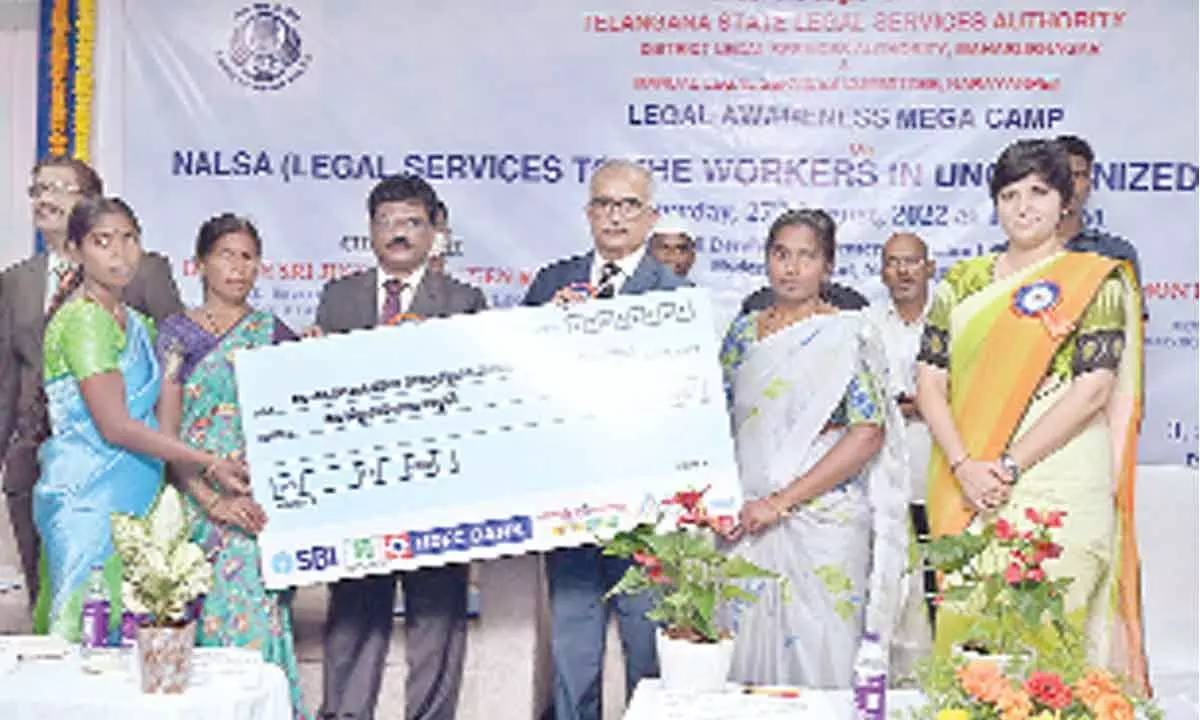 Telangana High Court Justice Naveen Rao distsributing loan cheques to members of Self Help Groups during the Legal Awarness Mega Camp held in Narayanpet on Saturday. District Collector Harichandana is also seen.