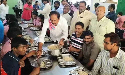MLA Dr. Sanjay Kumar serving breakfast to students at Telangana Minority Residential Boys School in Jagtial on Monday