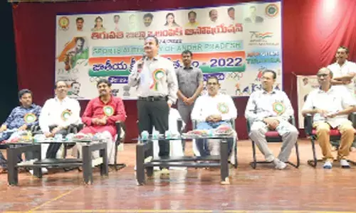 District Collector K Venkataramana Reddy addressing the students and sports persons at Mahathi Auditorium on National Sports Day in Tirupati on Monday
