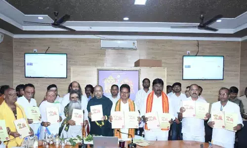 Srisailam temple Executive Officer S Lavanna releasing the poster of two new sevas to be introduced from September 5 on Monday