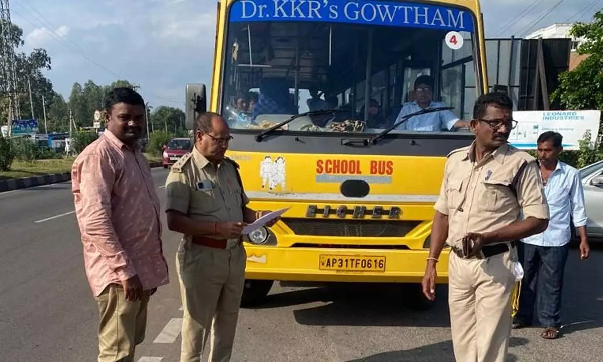 RTO officials checking the documents of the school buses on Tuesday during a special drive in Visakhapatnam