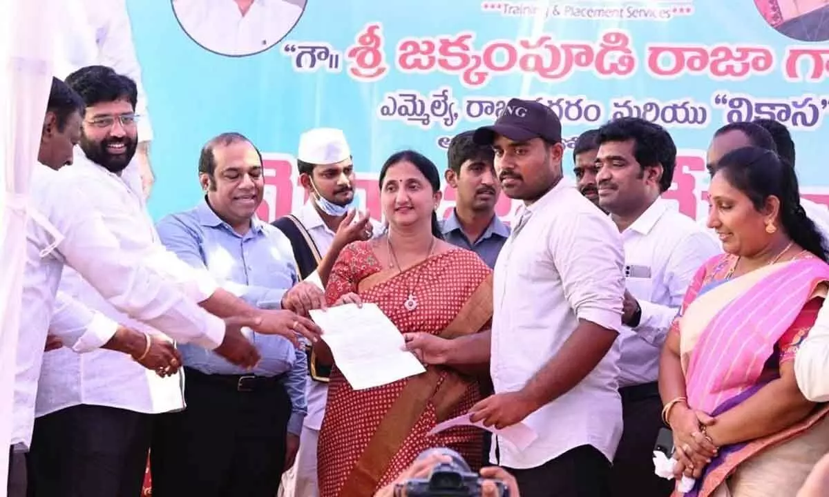 District Collector K Madhavi Latha and MLA Jakkampudi Raja handing over appointment letters to the selected candidates at the job fair at Bennayya Christian College in Burugupudi on Friday