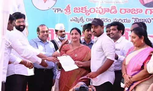 District Collector K Madhavi Latha and MLA Jakkampudi Raja handing over appointment letters to the selected candidates at the job fair at Bennayya Christian College in Burugupudi on Friday