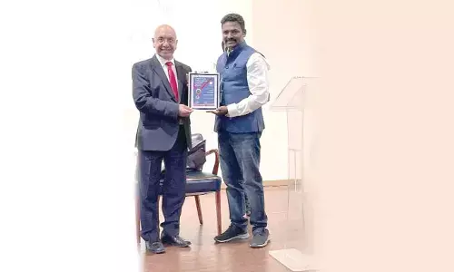 Dr Harshavardhan receiving the FBAA certificate from Virendra Sharma, MP, UK.