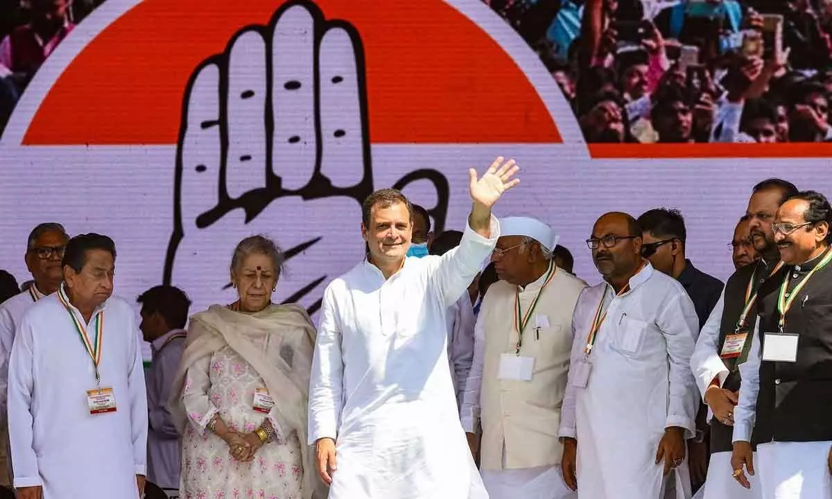Congress leader Rahul Gandhi waves at supporters during the Mehangai Par Halla Bol rally on price rise, at Ramlila Maidan in New Delhi on Sunday