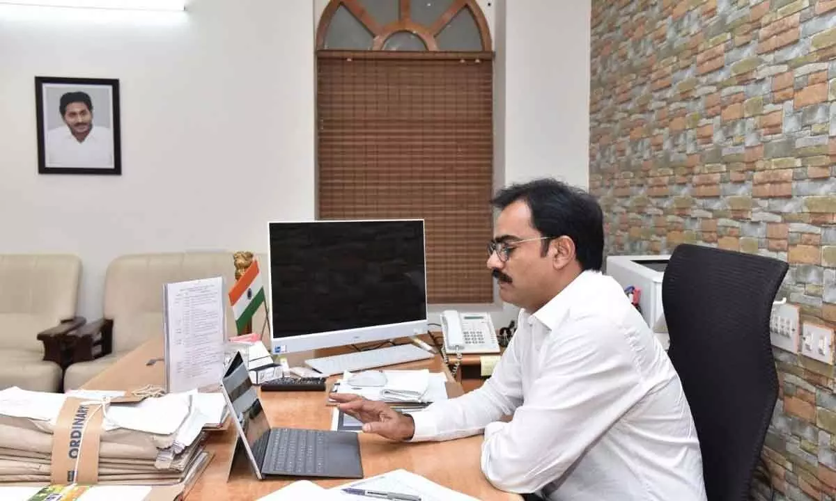 District Collector M Venugopal  Reddy participating in a videoconference from his camp  office in Guntur on Monday