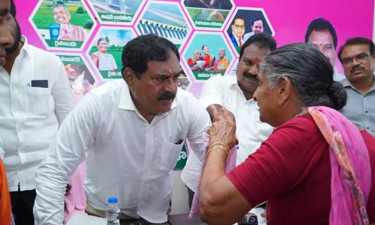 Minister for Panchayat Raj and Rural Development Errabelli Dayakar Rao interacting with a woman at a programme in Parvathagiri of Warangal district on Monday