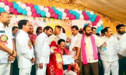 Minister Jagadish Reddy felicitating best teacher awardee Shaik Waheed of Akshaya School of Halia at a programme held in Nalgonda on Monday