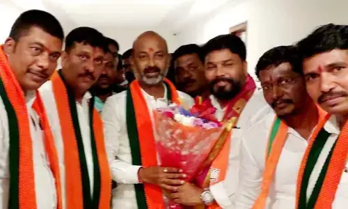 BJP state president, Mp Bandi Sanjay Kumar congratulating newly appointed Khamamm Parliamentary convener Namburi Ramalingeswara Rao in party office at Hyderabad on Monday .