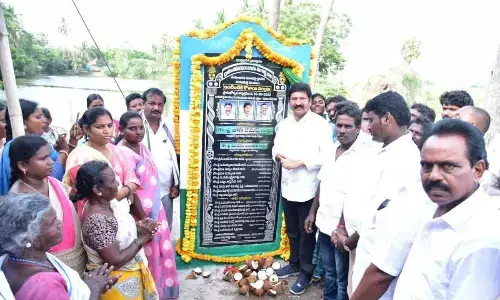 Housing Minister Jogi Ramesh unveiling the plaque of Jal Jeevan Mission project at Satuluru on Monday