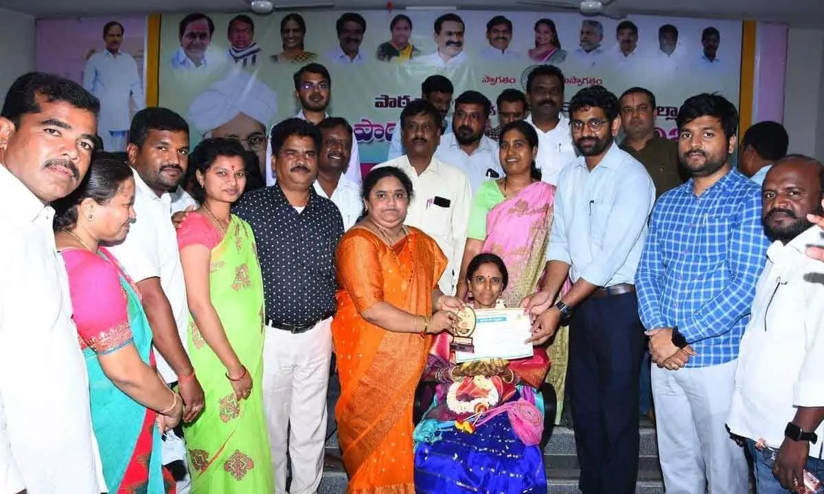 Collector, ZP chairperson honouring a teacher in Kamareddy on Tuesday