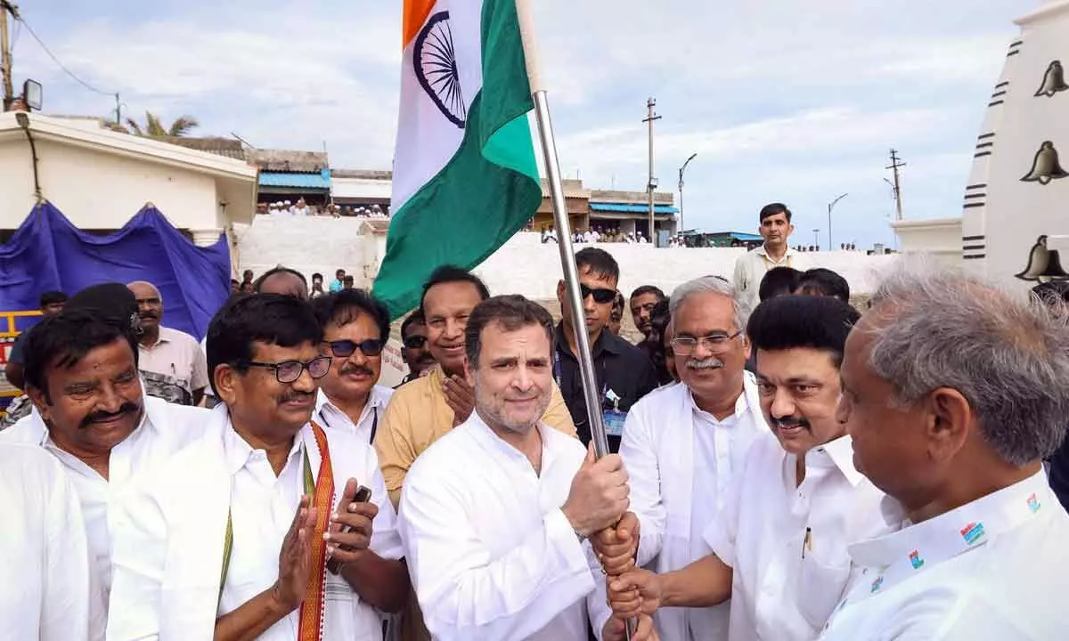 Tamil Nadu CM MK Stalin, Rajasthan CM Ashok Gehlot and Chhattisgarh CM Bhupesh Baghel hand over the national flag to Congress leader Rahul Gandhi during the launch of nationwide Bharat Jodo Yatra, in Kanyakumari on Wednesday