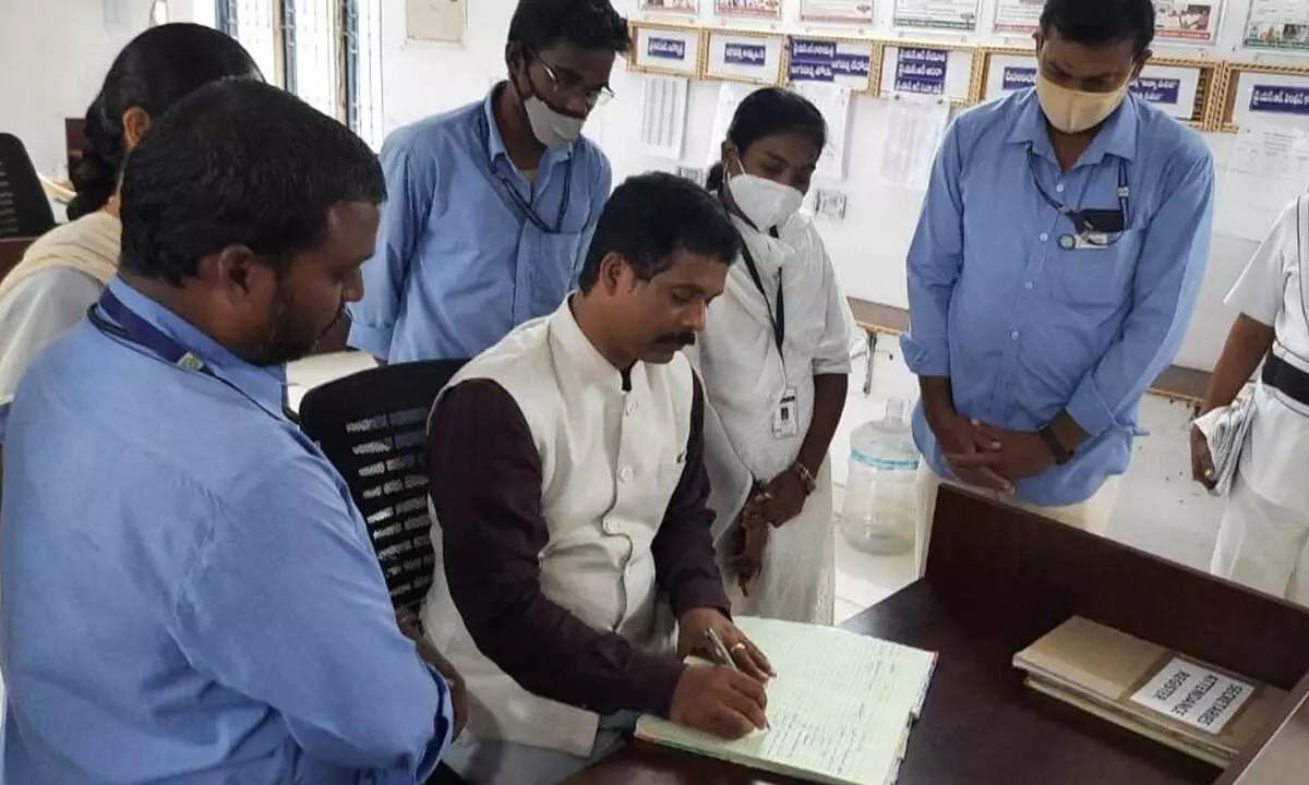 District Collector S Dilli Rao checking the registers while inspecting secretariats in Vijayawada on Wednesday