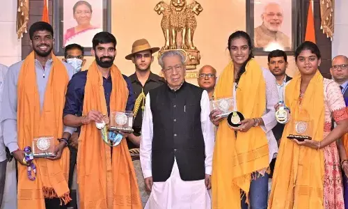 Governor Biswabhusan Harichandan along with PV Sindhu, Kidambi Srikanth, R Satwik Sairaj and V Jyothi Surekha after felicitating them at Raj Bhavan in Vijayawada on Wednesday