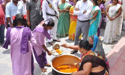 District Collector  P Koteshwara Rao inspecting the midday meal being served to students at Zilla Parishad High School for Girls in Pathikonda on Wednesday.
