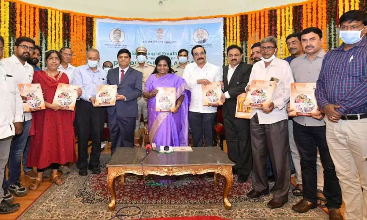 Governor Dr Tamilisai Soundararajan releasing the Coffee Table book titled Rediscovering Self in Selfless Service” a photographic presentation of activities and initiatives of her 3rd year in office as the Governor of Telangana State, at Raj Bhavan in Hyderabad on Thursday