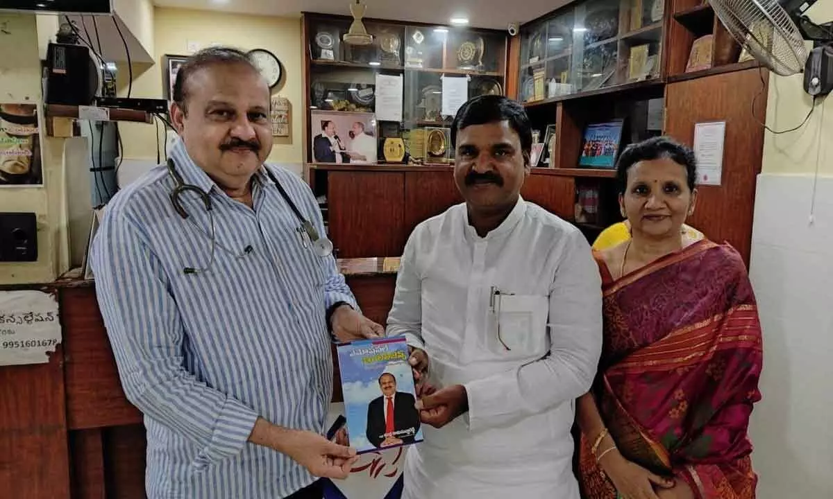 Dr Indla Ramasubba Reddy presenting a book written by him to Deputy Chief Minister Amzath Basha at VIMHANS in Vijayawada on Thursday