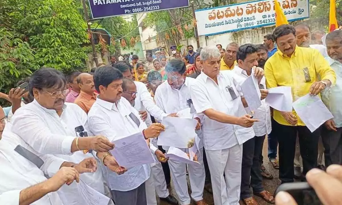 TDP burns FIR copies at police station