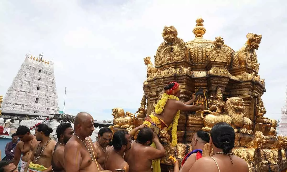 Priests offering Pavitramalas to the deities on the temple Vimanam (dome) on the second day of Pavithrotsavam at Tiruchanur temple on Friday