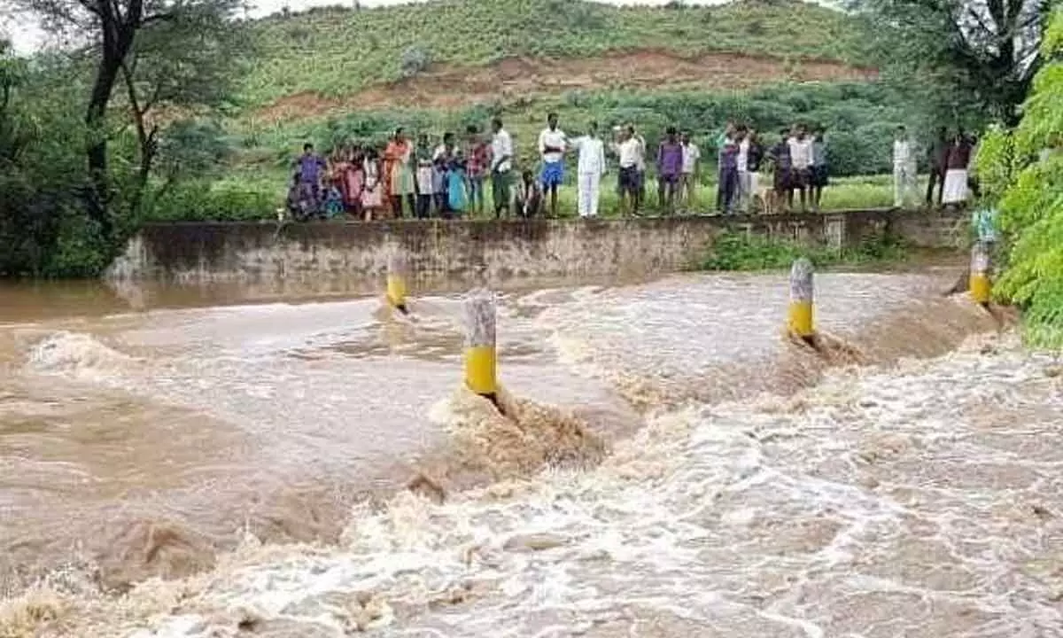 Villagers looking at the floodwaters in Mylarampalle village