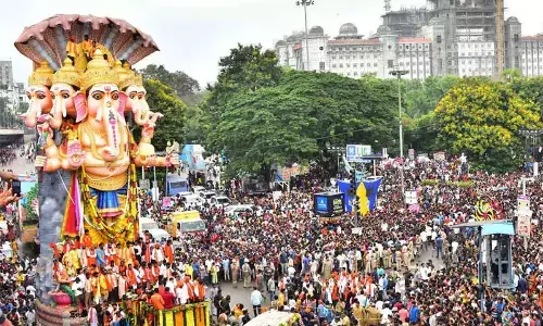 Devotees participate in the procession of Khairatabad Ganesha on way to Hussain Sagar for immersion, in Hyderabad on Friday.  Photo: Srinivas Setty