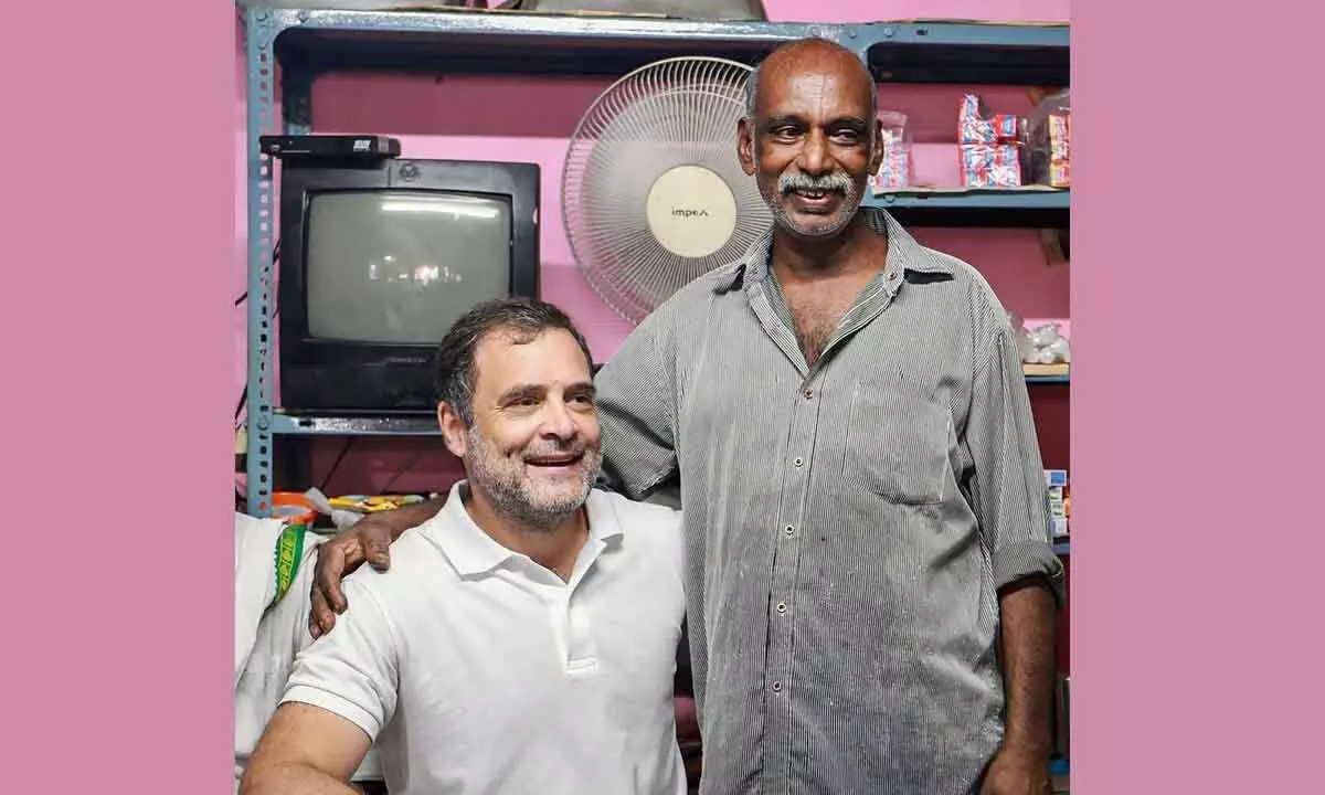 Congress leader Rahul Gandhi poses for photo with a shopkeeper as he takes a break for tea during the Bharat Jodo Yatra at Parassala, Thiruvananthapuram on Sunday