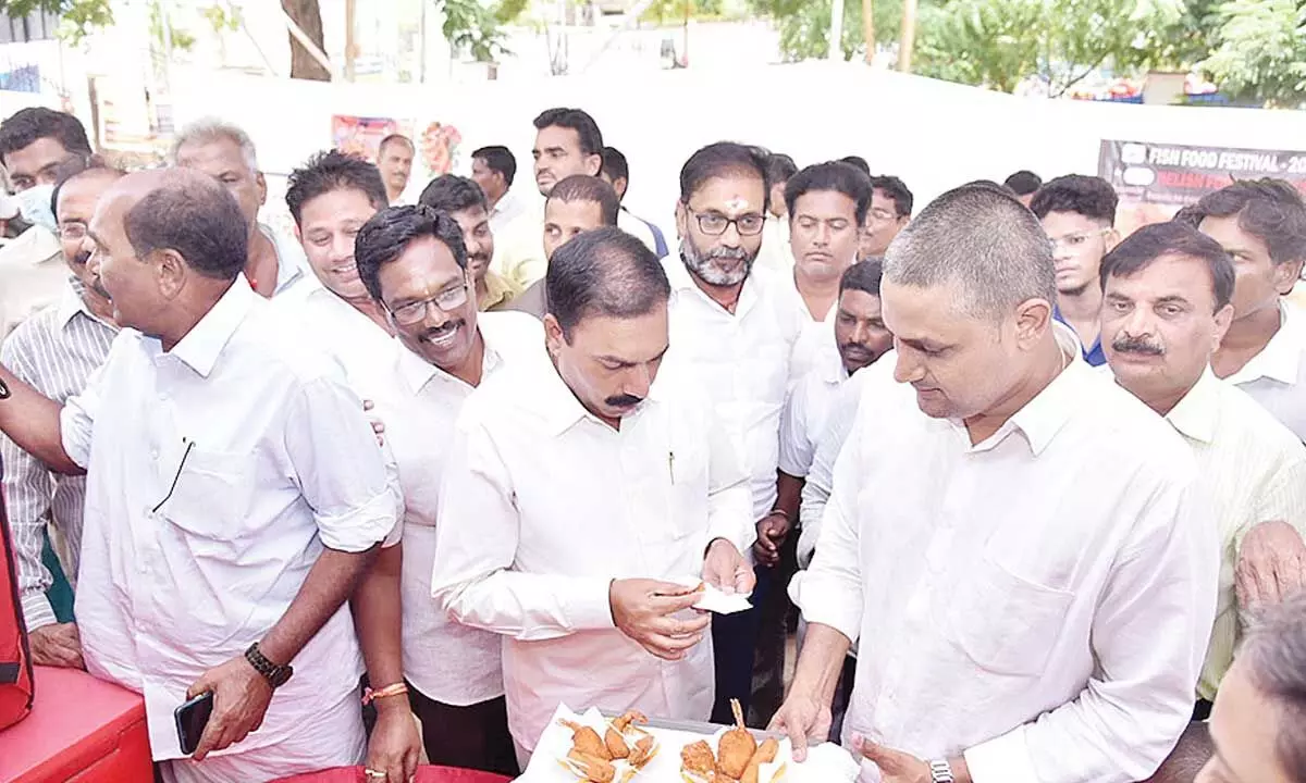 Agriculture Minister Kakani Govardhan Reddy visiting a stall at the seafood festival at VR College Grounds in Nellore on Monday