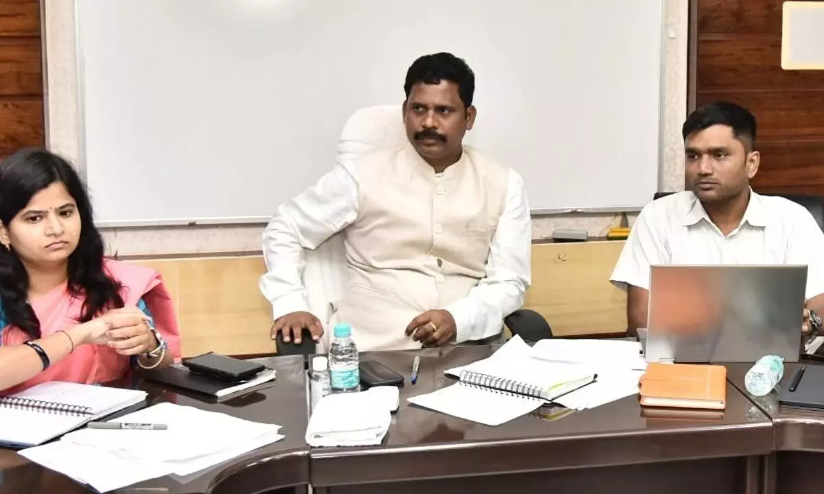 AP Housing Corporation MD Bharat Gupta holding review meeting with officials in Vijayawada on Monday. District Collector S Dilli Rao also seen.