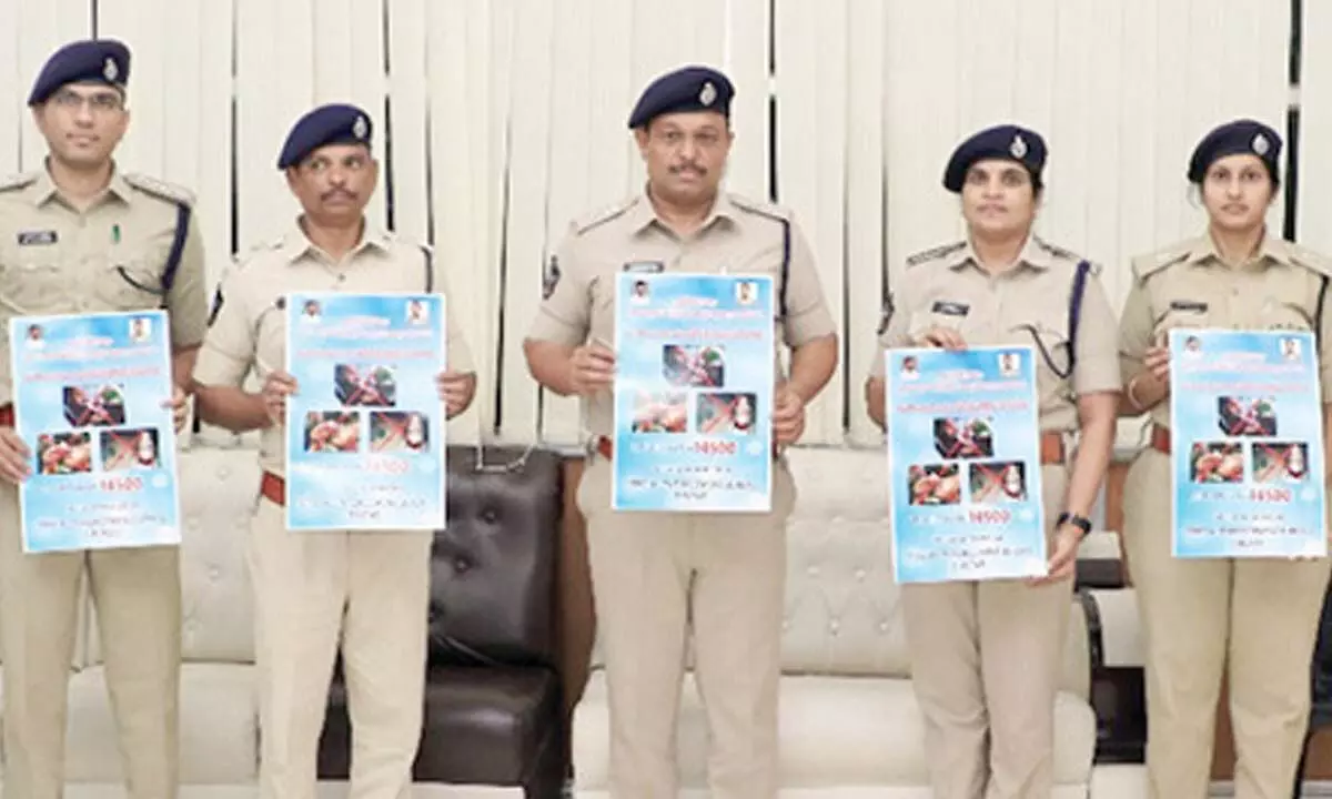 Superintendent of Police P Parameswar Reddy along with  SEB Additional SP Supraja, Superintendent Swathi  releasing a tollfree number poster at DPO in Tirupati on Monday