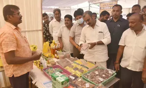 Union Minister Dr L Murugan observing fish products at a stall in the city on Sunday